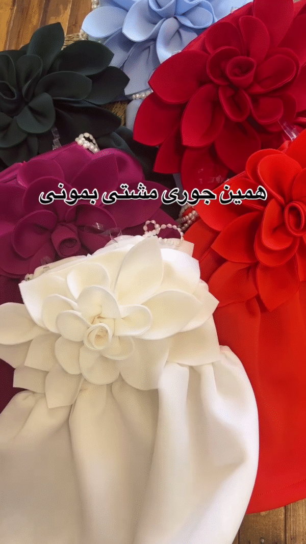 A collection of outfits, likely dresses or rompers for a young child, characterized by a very bold and voluminous large floral accent. - Image 2